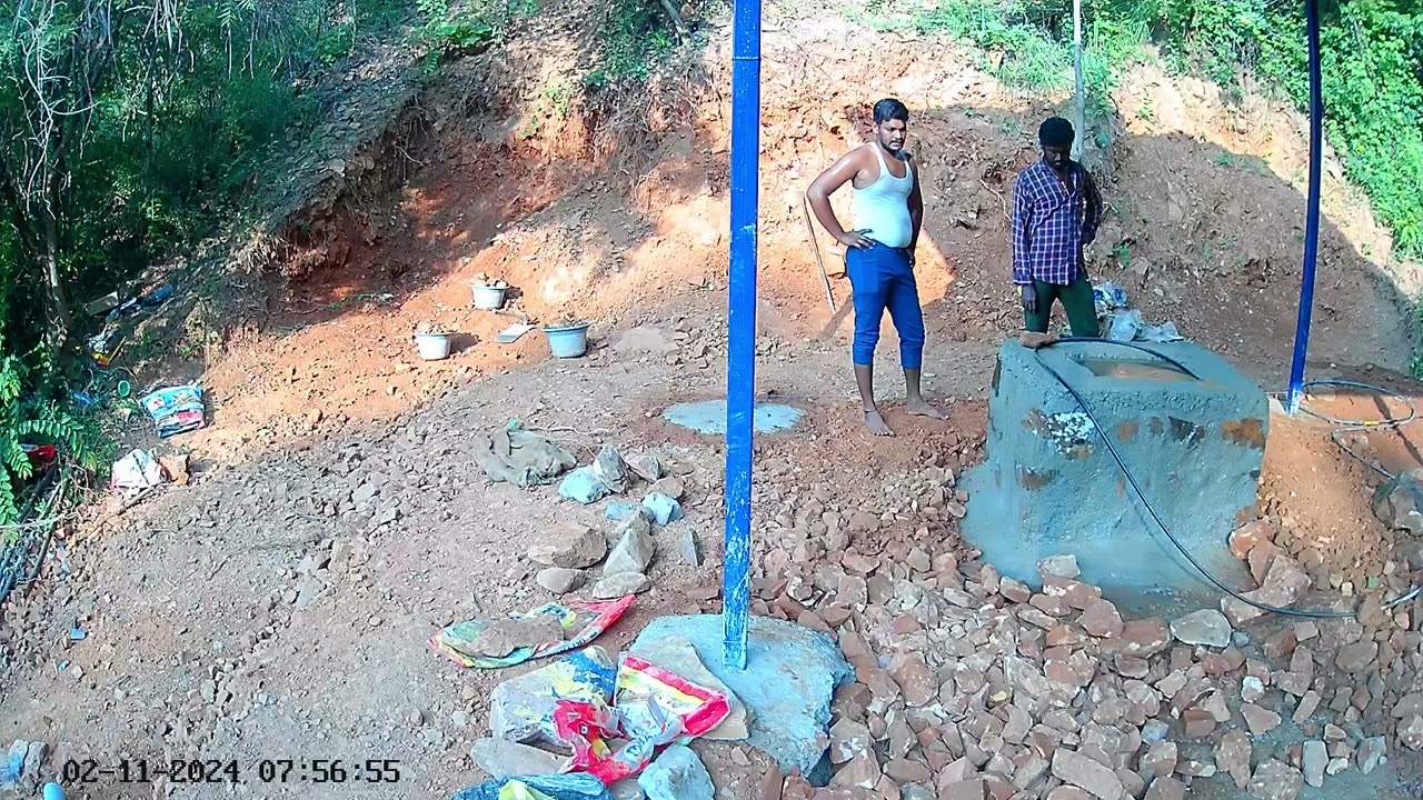 Red soil being poured around the shrine in place of rock.