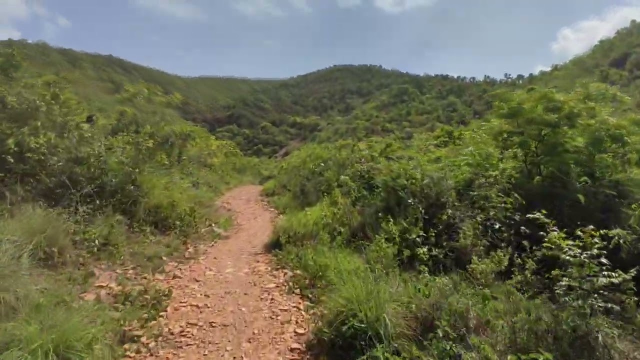 The finished road, with a two-wheeler riding up it to the temple.