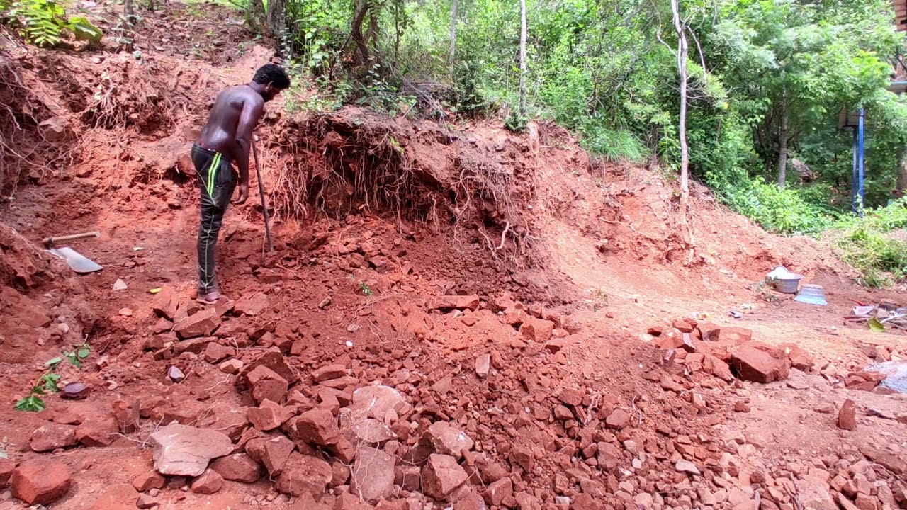 Digging into the hill above and pouring the rock and soil down.